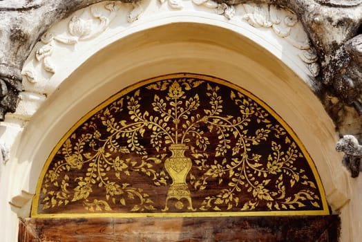 the detail of  thai gold painting pattern on ancient  wood plate,shallow focus,Lampang temple,Thailand