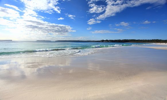 Beautiful Australian beach  in the morning with cloud reflections on the sand.