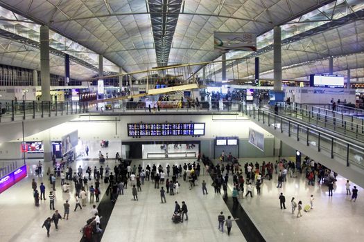 HONG KONG, CHINA - APRIL 26: Passengers in the airport main lobby on April 26, 2014 in Hong Kong, China. The Hong Kong airport handles more than 70 million passengers per year.