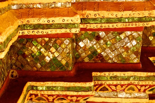 ancient stucco work that decorated with mirror and precious stone ,Lampang temple,Thailand