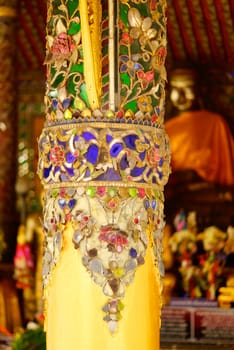 the detail of ancient thai decorated pattern that include handcraft wood carving work,gold painting and decorated with gold plate,mirror and precious stone,Lampang temple,Thailand