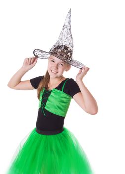 Girl in tutu skirt and halloween hat isolated on white