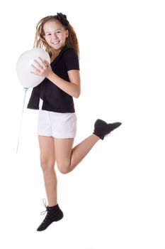 Happy girl jumping with heart-shaped balloon over white