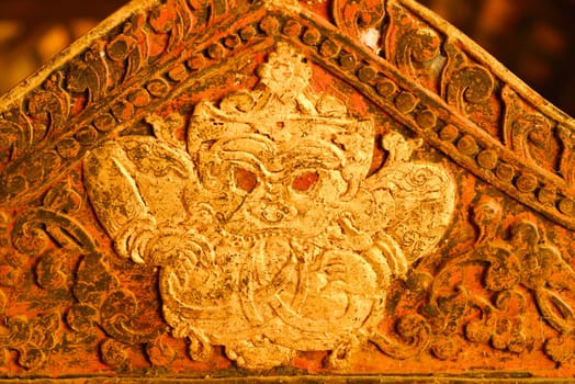 the detail of ancient thai decorated pattern that include handcraft wood carving work,gold painting and decorated with gold plate,mirror and precious stone,Lampang temple,Thailand