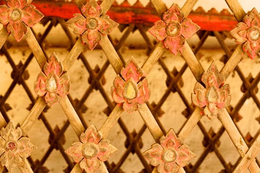 the detail of ancient thai decorated pattern that include handcraft wood carving work,gold painting and decorated with gold plate,mirror and precious stone,Lampang temple,Thailand