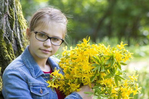 young girl with big bouquet of spring flowers
