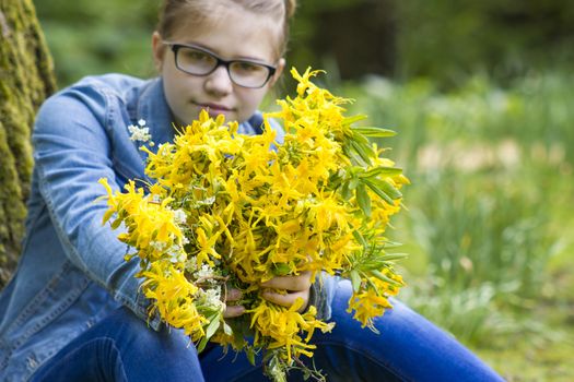 young girl with big bouquet of spring flowers