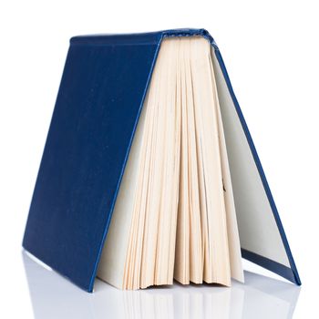 Old book on white background, on a table