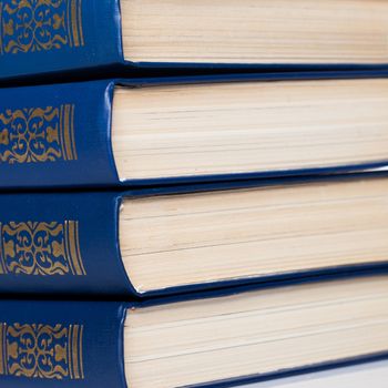 Stack of old books on white background