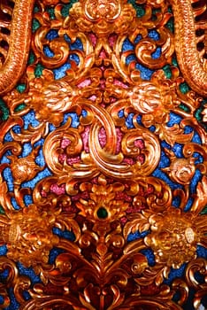 the detail of ancient thai decorated pattern that include handcraft wood carving work,gold painting and decorated with gold plate,mirror and precious stone,Chiang rai temple,Thailand