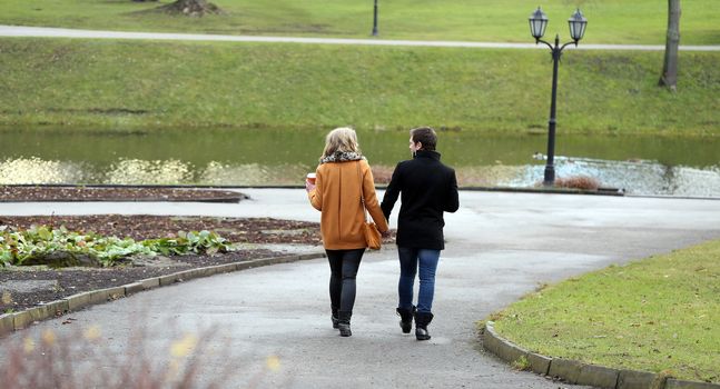 Autumn. Cute couple walk in the park