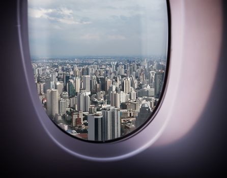 beautiful city view of Bangkok with blue sky from plane window