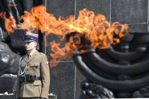 Warsaw, Poland – April 19, 2014: Celebration of the 71 anniversary of the Warsaw Ghetto Uprising. Menorah with burning flame.