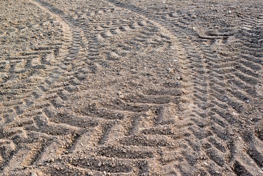 Tracks of a heavy tractor on plowed field