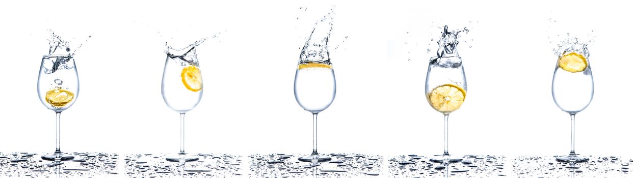 Lemon splashing into glasses full of water on white background