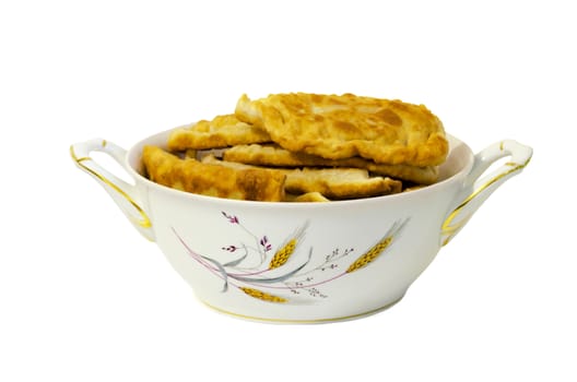 A large plate with fried pasties isolated on white background