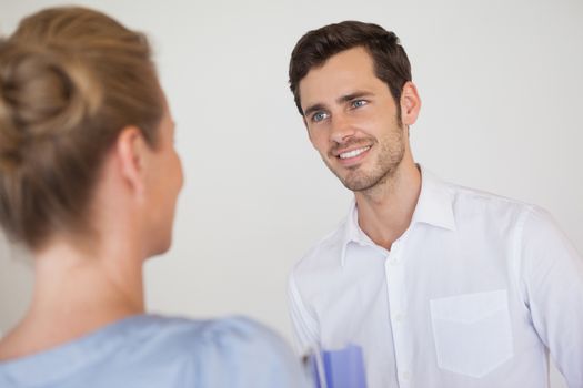 Casual business people looking at each other in the office