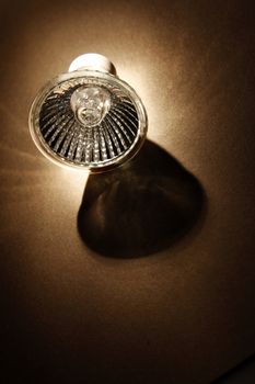 Halogen light bulb on brown background