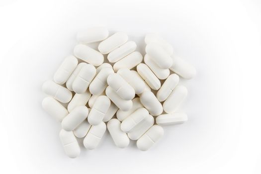 Pile of pills on plain background