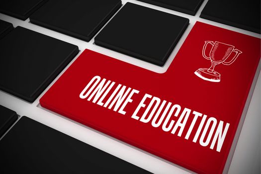 The word online education and winners cup on black keyboard with red key