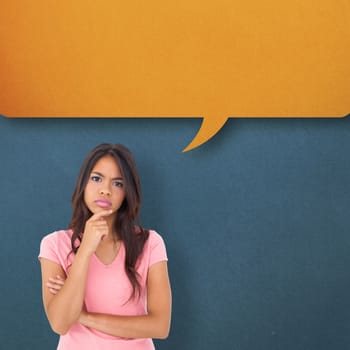 Pretty brunette thinking against speech bubble