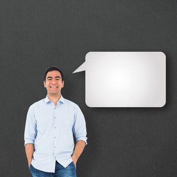 Smiling casual man standing against speech bubble