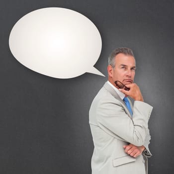 Thinking businessman against speech bubble