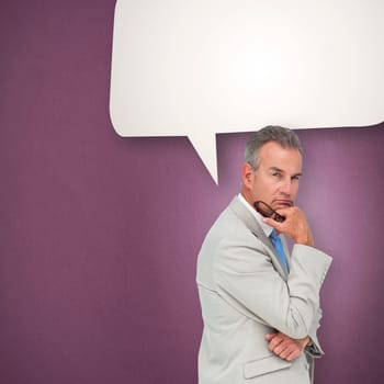 Thinking businessman against speech bubble