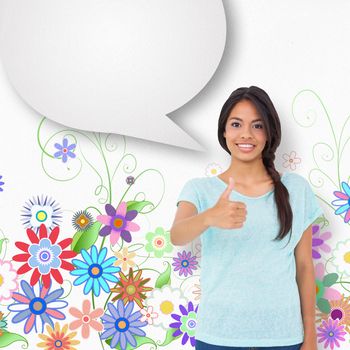 Happy brunette giving thumbs up with speech bubble against digitally generated girly floral design