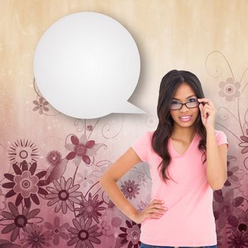 Pretty brunette thinking with speech bubble against digitally generated girly floral design