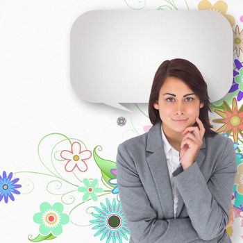 Smiling thoughtful businesswoman with speech bubble against digitally generated girly floral design