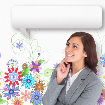 Smiling thoughtful businesswoman with speech bubble against digitally generated girly floral design