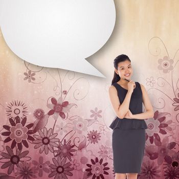 Thoughtful asian businesswoman with speech bubble against digitally generated girly floral design