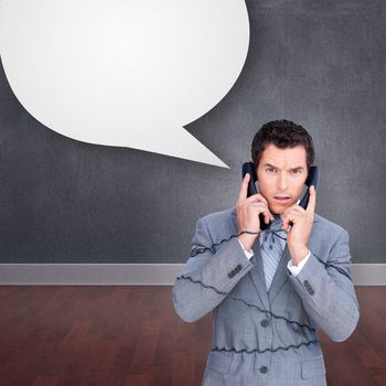 Angry businessman tangle up in phone wires against speech bubble