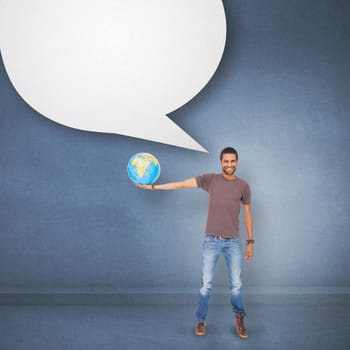 Handsome man holding out a globe against speech bubble