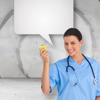 Happy surgeon holding an apple and smiling at camera against speech bubble