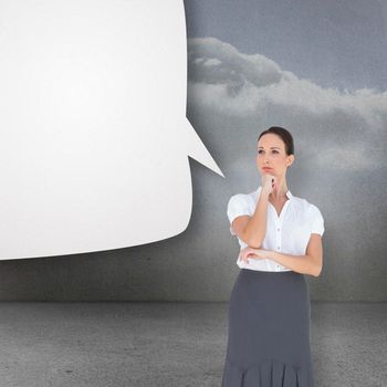Pensive elegant businesswoman posing against clouds in a room with speech bubble