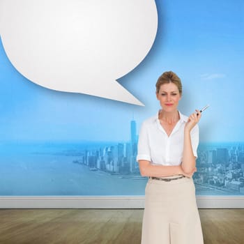 Thinking businesswoman against city projection on wall with speech bubble