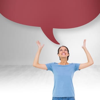 Pretty brunette gesturing against bright white room with speech bubble