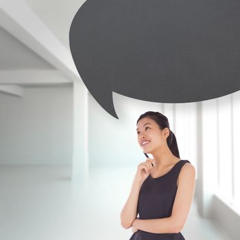 Thinking businesswoman with speech bubble against white room with windows