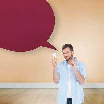 Charming model holding a bulb in right hand against speech bubble