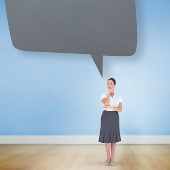 Pensive elegant businesswoman posing against speech bubble