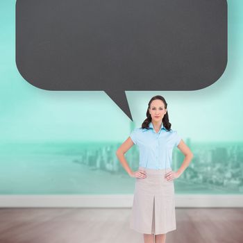 Serious stylish businesswoman posing with speech bubble against city projection on wall