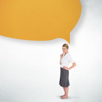 Thinking businesswoman with speech bubble against white wall