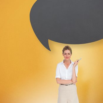 Thinking businesswoman with speech bubble against yellow background with vignette