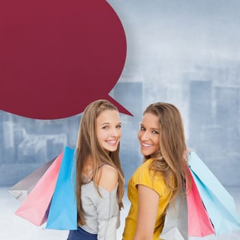 Two young women with shopping bags with speech bubble against city scene in a room