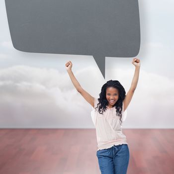 A young happy woman  with speech bubble against clouds in a room