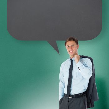 Smiling businessman holding his jacket with speech bubble against blue background with vignette