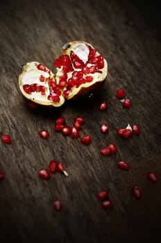 Pomegranate on wooden table, still life