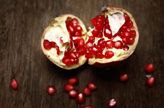 Pomegranate on wooden table, still life